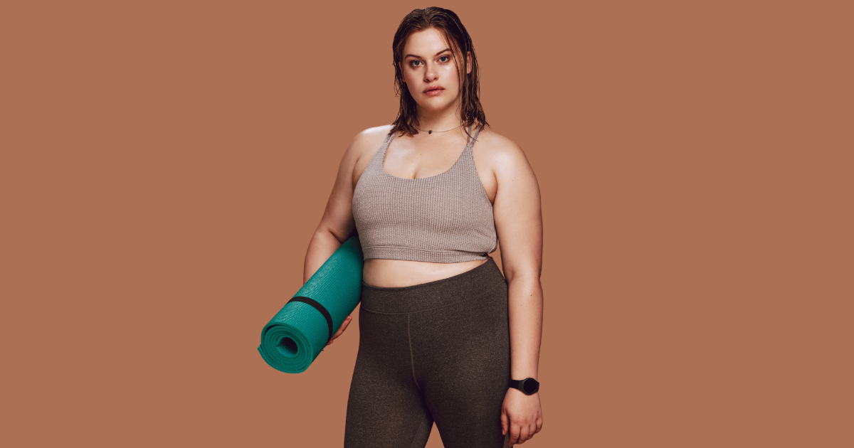 woman with a yoga mat beside her side